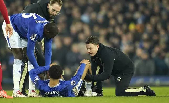 Everton's Iliman Ndiaye receives medical attention during the English Premier League soccer match between Everton and Liverpool, Liverpool, England, Wednesday, Feb.12, 2025. (AP Photo/Dave Thompson)