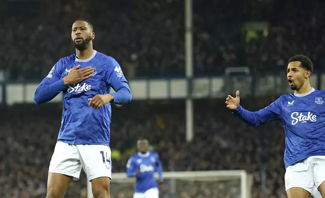 Everton's Beto, left, celebrates with teammates after scoring his side's opening goal during the English Premier League soccer match between Everton and Liverpool, Liverpool, England, Wednesday, Feb.12, 2025. (AP Photo/Dave Thompson)
