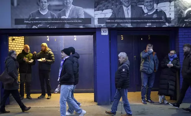 Fans walk outside of the Goodison Park stadium ahead of the English Premier League soccer match between Everton and Liverpool in Liverpool, England, Wednesday, Feb.12, 2025. (AP Photo/Dave Thompson)