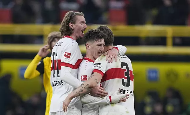 Stuttgart player celebrate at the end of the German Bundesliga soccer match between Borussia Dortmund and VfB Stuttgart at the Signal-Iduna Park in Dortmund, Germany, Saturday, Feb. 8, 2025. (AP Photo/Martin Meissner)