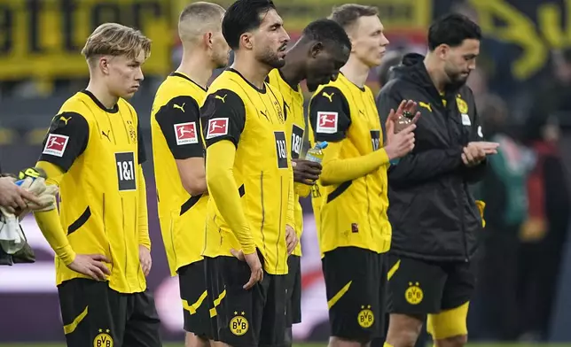 Dortmund players stand on the pitch at the end of the German Bundesliga soccer match between Borussia Dortmund and VfB Stuttgart at the Signal-Iduna Park in Dortmund, Germany, Saturday, Feb. 8, 2025. (AP Photo/Martin Meissner)