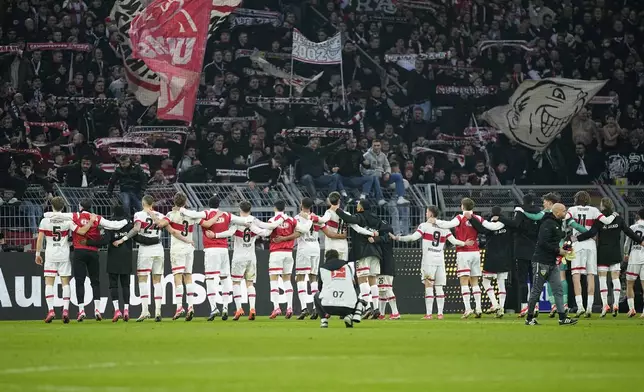 Stuttgart player celebrate at the end of the German Bundesliga soccer match between Borussia Dortmund and VfB Stuttgart at the Signal-Iduna Park in Dortmund, Germany, Saturday, Feb. 8, 2025. (AP Photo/Martin Meissner)