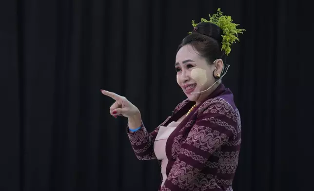 Artist with traditional attire put Thanakha, traditional make-up, on her face as she takes part in performance competition show aiming to submit the traditional culture of Thanakha to UNESCO's Intangible Cultural Heritage of Humanity, Wednesday, Feb.12, 2025 in Yangon, Myanmar. (AP Photo/Thein Zaw)