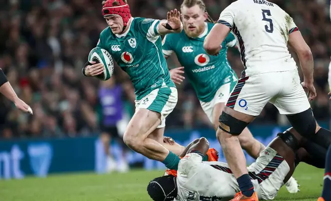 Ireland's Josh van der Flier is tackled by England's Maro Itoje during the Six Nations rugby union match between Ireland and England at the Aviva Stadium in Dublin, Saturday, Feb. 1, 2025. (AP Photo/Peter Morrison)