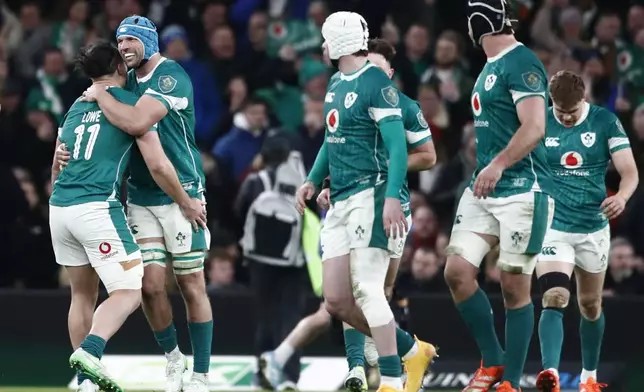 Ireland's Tadhg Beirne, second left, celebrates after scoring a try during the Six Nations rugby union match between Ireland and England at the Aviva Stadium in Dublin, Saturday, Feb. 1, 2025. (AP Photo/Peter Morrison)