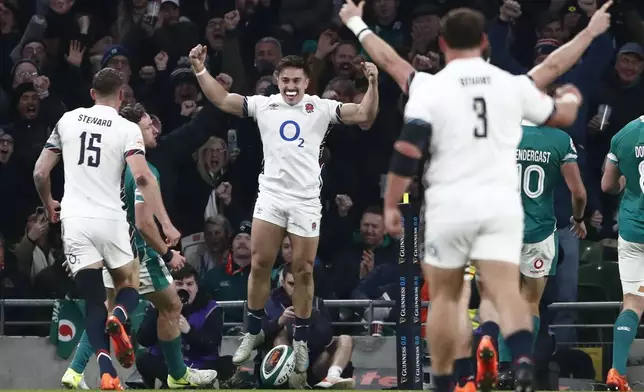 England's Cadan Murley, center, celebrates after scoring the opening try during the Six Nations rugby union match between Ireland and England at the Aviva Stadium in Dublin, Saturday, Feb. 1, 2025. (AP Photo/Peter Morrison)