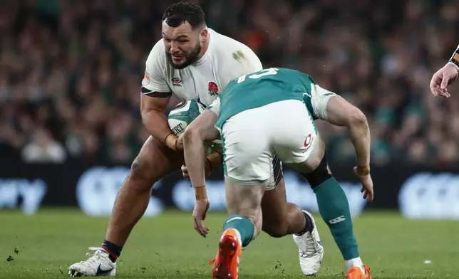 England's Ellis Genge on the charge during the Six Nations rugby union match between Ireland and England at the Aviva Stadium in Dublin, Saturday, Feb. 1, 2025. (AP Photo/Peter Morrison)