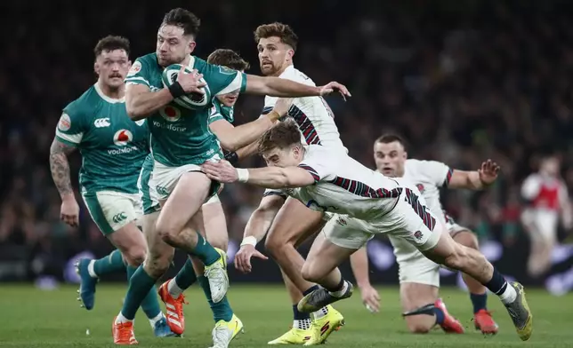 Ireland's Hugo Keenan is tackled by England's Tommy Freeman during the Six Nations rugby union match between Ireland and England at the Aviva Stadium in Dublin, Saturday, Feb. 1, 2025. (AP Photo/Peter Morrison)