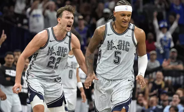 Orlando Magic forward Franz Wagner (22) celebrates after forward Paolo Banchero (5) made the game winning shot in the closing moments of an NBA basketball game against the San Antonio Spurs Saturday, Feb. 8, 2025, in Orlando, Fla. (AP Photo/John Raoux)