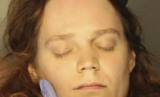 In this Jan., 2023 booking photo provided by the Delaware County, Pennsylvania, District Attorney's Office, Jack LaSota refused to speak and kept her eyes closed while being photographed after being detained in a hotel in suburban Pennsylvania on Jan. 23, 2023. (Delaware County, Pennsylvania, District Attorney's Office via AP)