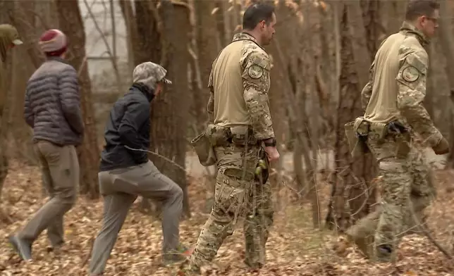 FBI agents search a neighborhood in Chapel Hill, North Carolina on Wednesday, Feb. 5, 2025., where Teresa Youngblut and Felix Bauckholt, who were involved in the shooting death of a U.S. Border Patrol agent in Vermont, had been renting homes, their landlord told The Associated Press. (WRAL-TV via AP)