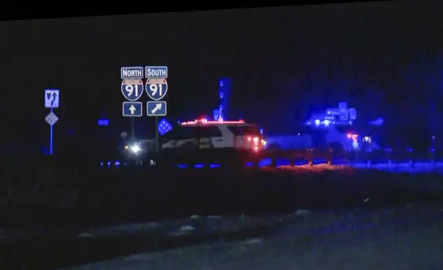 FILE - This image taken from video provided by WCAX shows police cars closing off a road after a shooting involving a U.S. Border Patrol agent on Interstate 91 near Coventry, Vt., on Jan. 20, 2025. (WCAX via AP, File)