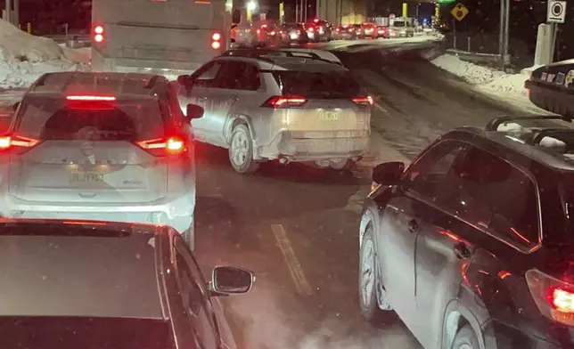 FILE- Cars are backed up at the US-Canada border in Stanstead, Quebec, after a shooting involving a U.S. Border Patrol agent in Coventry, Vt., on Jan. 20, 2025. (AP Photo/Chloe Jones, File)