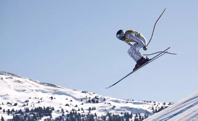 Czech Republic's Ester Ledecka is airborne during a women's downhill race, at the Alpine Ski World Championships, in Saalbach-Hinterglemm, Austria, Saturday, Feb. 8, 2025. (AP Photo/Gabriele Facciotti)