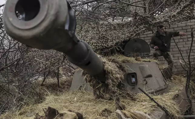 FILE - In this photo provided by Ukraine's 24th Mechanized Brigade press service, a soldier prepares to fire a howitzer towards Russian positions on the front line near Chasiv Yar, Donetsk region, Ukraine, Friday, Feb. 7, 2025. (Oleg Petrasiuk/Ukraine's 24th Mechanized Brigade via AP, File)