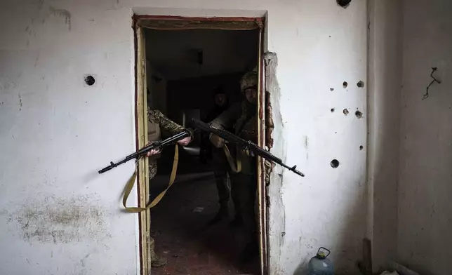 FILE - Ukrainian soldiers of the Da Vinci Wolves Battalion train not far from the front line in the Pokrovsk area of the Donetsk region, Ukraine, Jan. 29, 2025. (AP Photo/Evgeniy Maloletka, File)