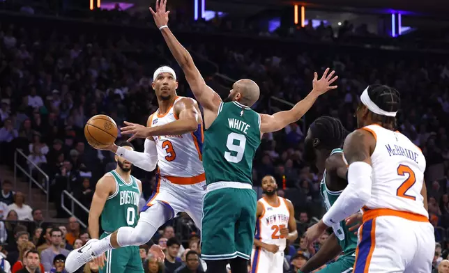 New York Knicks guard Josh Hart (3) drives to the basket against Boston Celtics guard Derrick White (9) during the first half of an NBA basketball game, Saturday, Feb. 8, 2025, in New York. (AP Photo/Noah K. Murray)