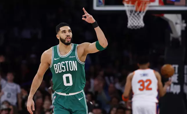 Boston Celtics forward Jayson Tatum (0) reacts after making a 3-point shot against the New York Knicks during the first half of an NBA basketball game, Saturday, Feb. 8, 2025, in New York. (AP Photo/Noah K. Murray)