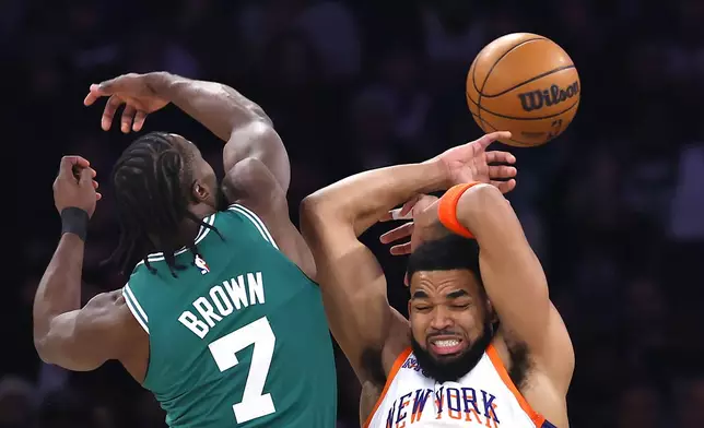Boston Celtics guard Jaylen Brown (7) battles New York Knicks center Karl-Anthony Towns for the ball during the first half of an NBA basketball game, Saturday, Feb. 8, 2025, in New York. (AP Photo/Noah K. Murray)