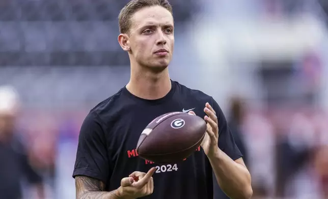 FILE - Then-Georgia quarterback Carson Beck (15) takes the field for early warm-ups before an NCAA college football game against Alabama, Saturday, Sept. 28, 2024, in Tuscaloosa, Ala. (AP Photo/Vasha Hunt, File)