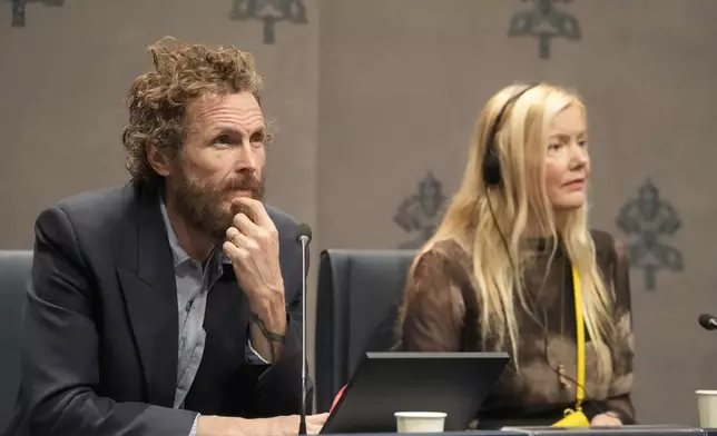 Italian artist Lorenzo Jovanotti Cherubini, left, and Icelandic artist Kristjana S. Williams attend a press conference presenting the exhibition "En Route" organized by the Vatican Apostolic Library exploring world tours of the late 19th century at the Vatican, Friday, Jan. 31, 2025. (AP Photo/Gregorio Borgia)