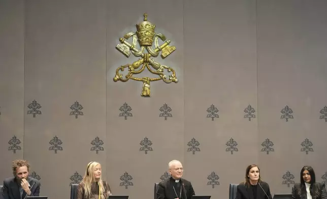 From left, Italian artist Lorenzo Jovanotti Cherubini, Icelandic artist Kristjana S. Williams, Mons. Angelo Vincenzo Zani, Vatican Archivist, Dior Artistic Director Maria Grazia Chiuri and Creative director, Chanakya International Karishma Swali attend a press conference presenting the exhibition "En Route" organized by the Vatican Apostolic Library exploring world tours of the late 19th century at the Vatican, Friday, Jan. 31, 2025. (AP Photo/Gregorio Borgia)