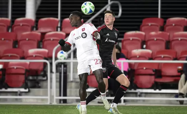 Toronto FC midfielder Richie Laryea (22) and D.C. United defender David Schnegg, right, battle for the ball during the second half of an MLS soccer match, Saturday, Feb. 22, 2025, in Washington. (AP Photo/Nick Wass)