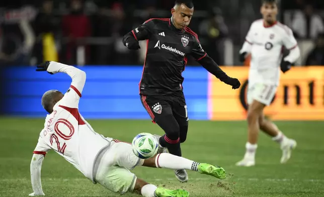D.C. United midfielder Randall Leal, top, and Toronto FC midfielder Deybi Flores (20) battle for the ball during the second half of an MLS soccer match, Saturday, Feb. 22, 2025, in Washington. (AP Photo/Nick Wass)