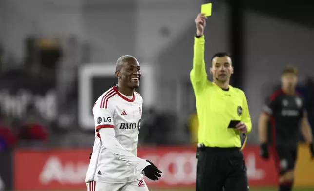 Toronto FC midfielder Deybi Flores, left, reacts after he was given a yellow card during the second half of an MLS soccer match against D.C. United, Saturday, Feb. 22, 2025, in Washington. (AP Photo/Nick Wass)