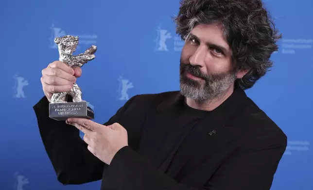 Venezuelan director Ivan Fund poses with the Silver Bear Jury Prize during the winner's photocall at the International Film Festival, Berlinale, in Berlin, Saturday, Feb. 22, 2025. (Ronny Hartmann/Pool via AP)