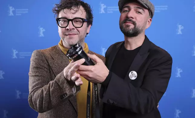 Mexican director Ernesto Martinez Bucio, right, and producer Alejandro Duran pose with a viewfinder as part of the Best First Feature Award during the winner's photocall at the International Film Festival, Berlinale, in Berlin, Saturday, Feb. 22, 2025. (Ronny Hartmann/Pool via AP)