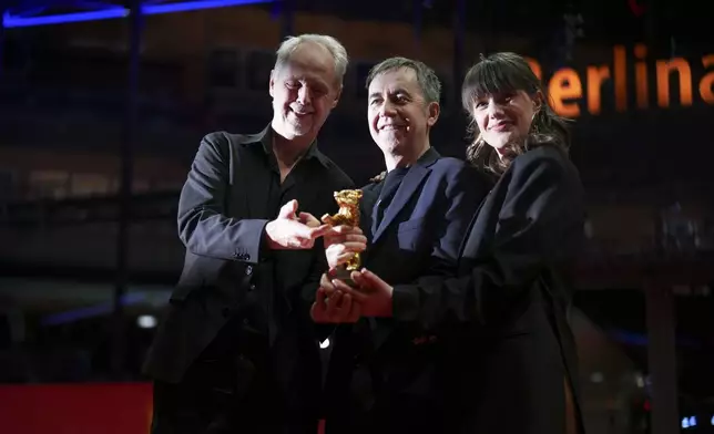Yngve Saether, from left, Dag Johan Haugerud and Hege Hauff Hvattum, winners of the Golden Bear for best film for 'Dreams (Sex Love)', pose for photographers at the winners photo call during the International Film Festival, Berlinale, in Berlin, Saturday, Feb. 22, 2025. (Photo by Scott A Garfitt/Invision/AP).