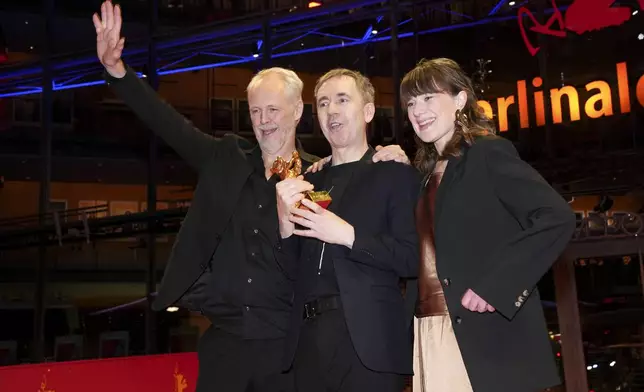 Yngve Saether, from left, Dag Johan Haugerud and Hege Hauff Hvattum, winners of the Golden Bear for best film for 'Dreams (Sex Love)', pose for photographers at the winners photo call during the International Film Festival, Berlinale, in Berlin, Saturday, Feb. 22, 2025. (Photo by Scott A Garfitt/Invision/AP).
