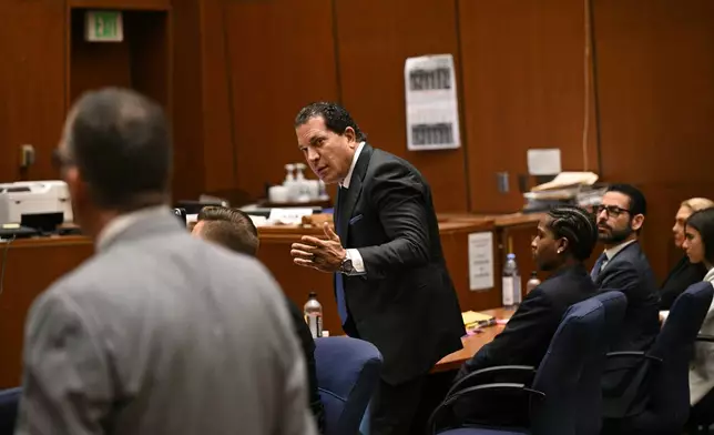 Attorney Joe Tacopina, center, speaks during the trial of his client A$AP Rocky, seated right, in Los Angeles, Friday, Feb. 14, 2025. (Patrick T. Fallon/Pool Photo via AP)