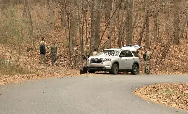 FBI agents search a neighborhood in Chapel Hill, North Carolina on Wednesday, Feb. 5, 2025, where Teresa Youngblut and Felix Bauckholt, who were involved in the shooting death of a U.S. Border Patrol agent in Vermont, had been renting homes in the neighborhood, their landlord told The Associated Press. (WRAL-TV via AP)