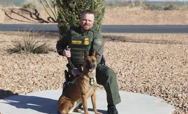 FILE - In this undated and unknown location photo released by the Department of Homeland Security shows Border Patrol Agent David Maland posing with a service dog. (Department of Homeland Security via AP, File)
