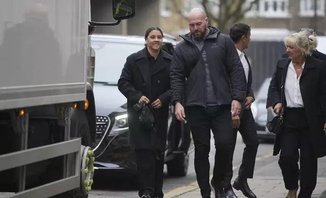 Australian football star, Chelsea striker Samantha Kerr, left, arrives a court as she was charged with causing a police officer harassment, alarm or distress during an incident in Twickenham, in London, Monday, Feb. 3, 2025. (AP Photo/Kin Cheung)