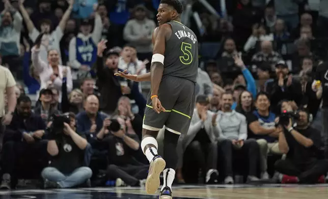 Minnesota Timberwolves guard Anthony Edwards (5) gestures after making a 3-point shot during the first half of an NBA basketball game against the Oklahoma City Thunder, Sunday, Feb. 23, 2025, in Minneapolis. (AP Photo/Abbie Parr)