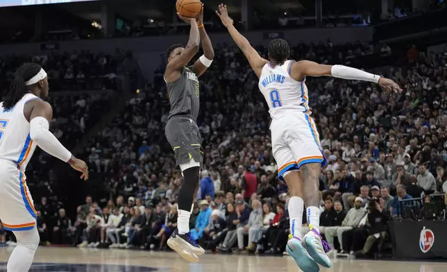 Minnesota Timberwolves guard Anthony Edwards (5) shoots over Oklahoma City Thunder forward Jalen Williams (8) during the first half of an NBA basketball game, Sunday, Feb. 23, 2025, in Minneapolis. (AP Photo/Abbie Parr)
