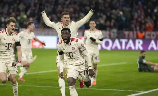 Bayern's Alphonso Davies, centre, celebrates after scoring his side's opening goal during the Champions League playoff second leg soccer match between FC Bayern Munich and Celtic Glasgow at the Allianz Arena in Munich, Germany, Tuesday, Feb. 18, 2025. (AP Photo/Matthias Schrader)