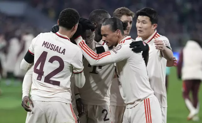 Bayern Munich players celebrate after Bayern's Alphonso Davies scored his side's opening goal during the Champions League playoff second leg soccer match between FC Bayern Munich and Celtic Glasgow at the Allianz Arena in Munich, Germany, Tuesday, Feb. 18, 2025. (AP Photo/Matthias Schrader)