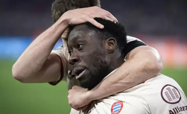 Bayern's Alphonso Davies celebrates with Bayern's Leon Goretzka after scoring his side's opening goal during the Champions League playoff second leg soccer match between FC Bayern Munich and Celtic Glasgow at the Allianz Arena in Munich, Germany, Tuesday, Feb. 18, 2025. (AP Photo/Matthias Schrader)