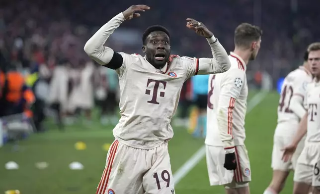 Bayern's Alphonso Davies, centre, celebrates after scoring his side's opening goal during the Champions League playoff second leg soccer match between FC Bayern Munich and Celtic Glasgow at the Allianz Arena in Munich, Germany, Tuesday, Feb. 18, 2025. (AP Photo/Matthias Schrader)