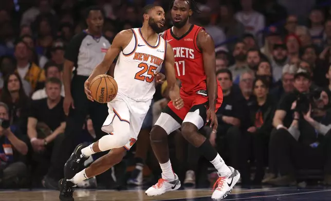 New York Knicks' Mikal Bridges (25) dribbles the ball against Houston Rockets' Tari Eason (17) during the first half of an NBA basketball game Monday, Feb. 3, 2025, in New York. (AP Photo/Pamela Smith)