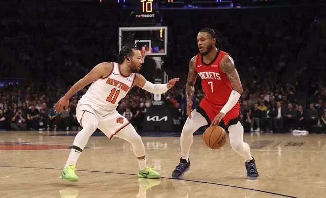 Houston Rockets' Cam Whitmore (7) dribbles the ball against New York Knicks' Jalen Brunson (11) during the first half of an NBA basketball game Monday, Feb. 3, 2025, in New York. (AP Photo/Pamela Smith)