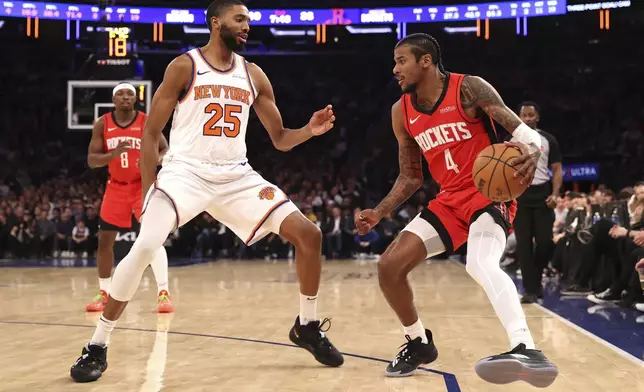 Houston Rockets' Jalen Green (4) dribbles the ball against New York Knicks' Mikal Bridges (25) during the first half of an NBA basketball game Monday, Feb. 3, 2025, in New York. (AP Photo/Pamela Smith)