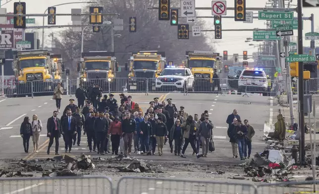 Pennsylvania Gov. Josh Shapiro, Philadelphia Mayor Cherelle Parker and other officials view the aftermath of a fatal small plane crashed in Philadelphia, Monday, Feb. 3, 2025. (AP Photo/Matt Rourke)