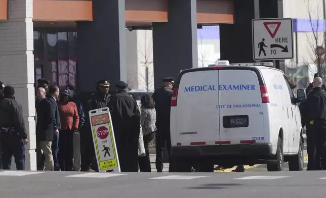Pennsylvania Gov. Josh Shapiro, Philadelphia Mayor Cherelle Parker and other officials view the aftermath of a fatal small plane crashed in Philadelphia, Monday, Feb. 3, 2025. (AP Photo/Matt Rourke)