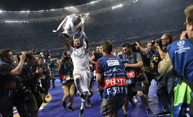 FILE - Real Madrid's Marcelo celebrates with the trophy after winning the Champions League Final soccer match between Real Madrid and Liverpool at the Olimpiyskiy Stadium in Kiev, Ukraine, May 26, 2018. (AP Photo/Pavel Golovkin, File)