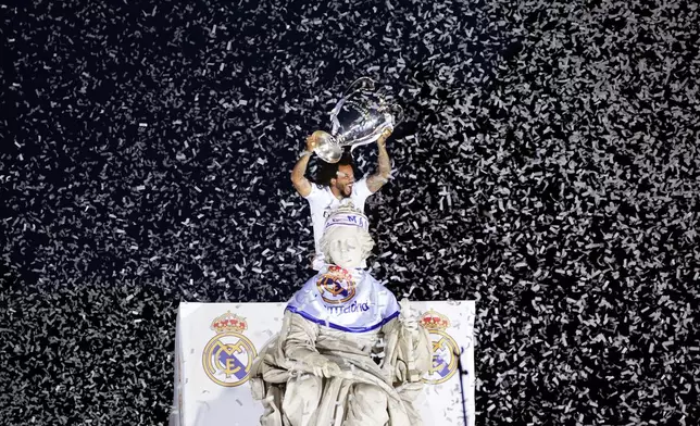 FILE - Real Madrid player Marcelo holds up the Champions League soccer trophy at the Cibeles square during a trophy parade in front of the City Hall in Madrid, Spain, May 29, 2022. (AP Photo/Andrea Comas, File)